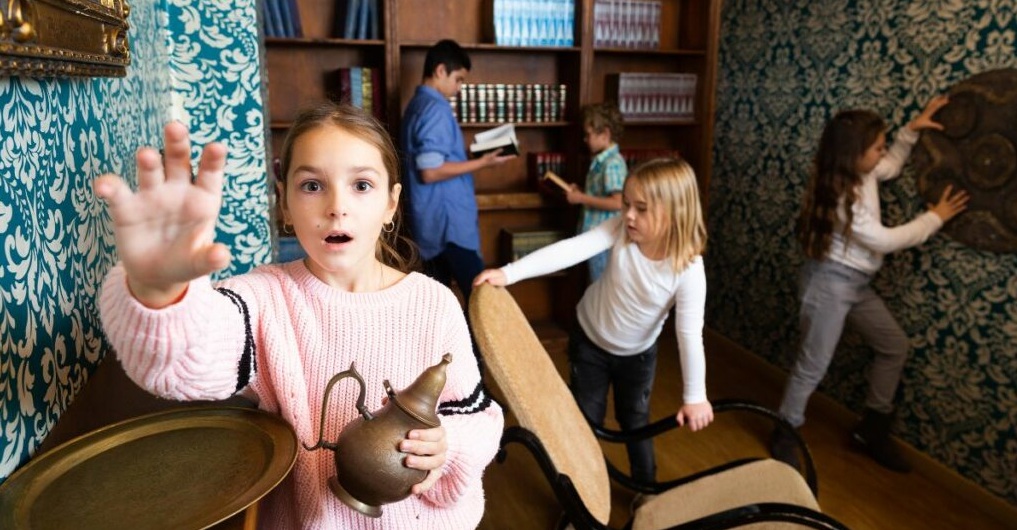 Children working together in team-building escape room challenge